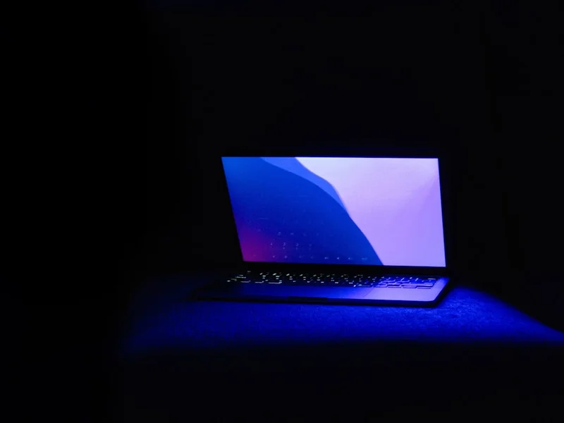 Laptop with glowing keyboard and blue light